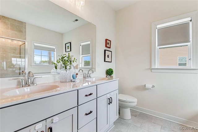 bathroom with a sink, visible vents, toilet, and a shower stall