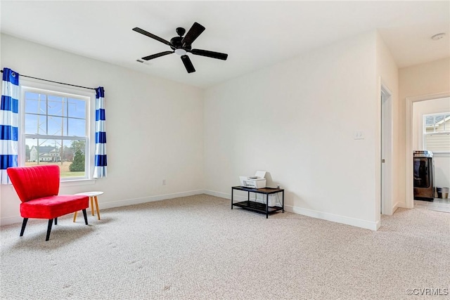 living area featuring a healthy amount of sunlight, baseboards, and carpet floors