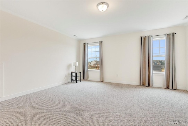 unfurnished room featuring baseboards and carpet floors