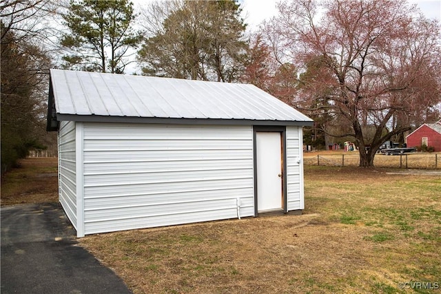 garage with fence and a storage unit