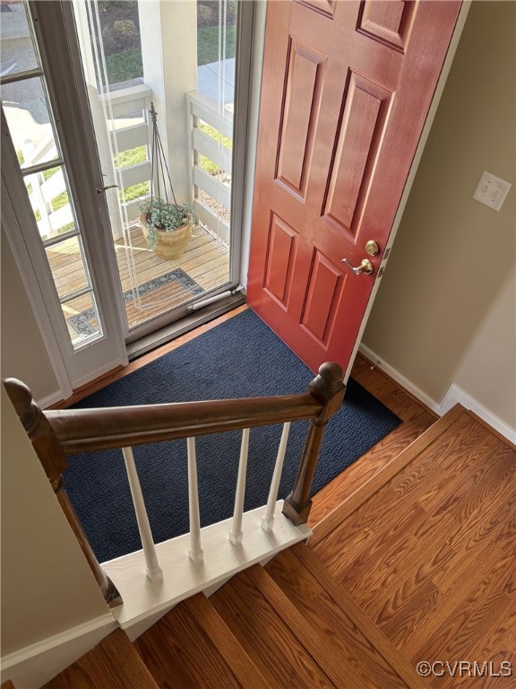 entryway with plenty of natural light, baseboards, and wood finished floors