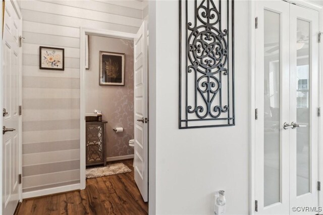 bathroom with wood finished floors and baseboards