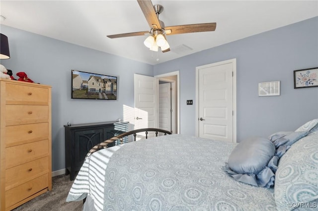 carpeted bedroom with ceiling fan and baseboards