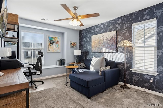 office featuring carpet, visible vents, ceiling fan, baseboards, and wallpapered walls