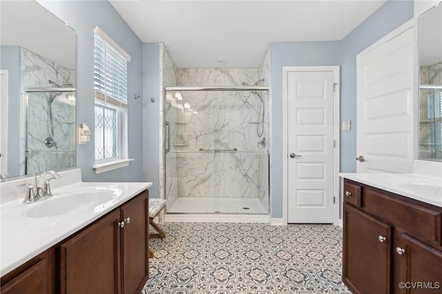 bathroom featuring two vanities, a sink, and a marble finish shower