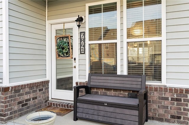 view of exterior entry with brick siding