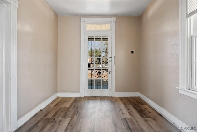 entryway featuring baseboards and wood finished floors