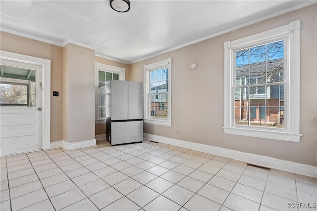 interior space with a healthy amount of sunlight, baseboards, and ornamental molding