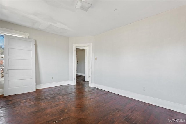 unfurnished room with baseboards and wood finished floors