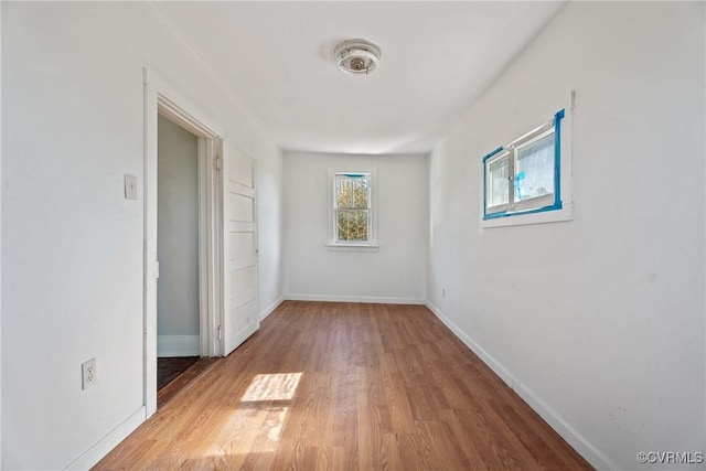 interior space with wood finished floors and baseboards