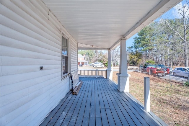 wooden deck with a porch and an attached carport