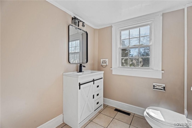 bathroom with a healthy amount of sunlight, visible vents, vanity, and tile patterned floors