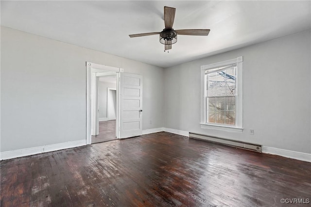 interior space featuring a baseboard heating unit, baseboards, and hardwood / wood-style flooring