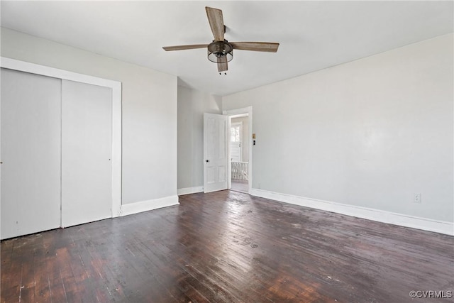 unfurnished bedroom featuring a closet, ceiling fan, baseboards, and wood finished floors