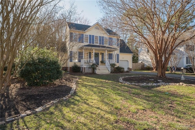 view of front of property featuring aphalt driveway, a porch, and a front lawn