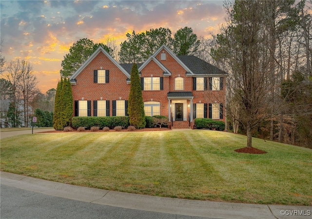 view of front of property with brick siding and a front lawn