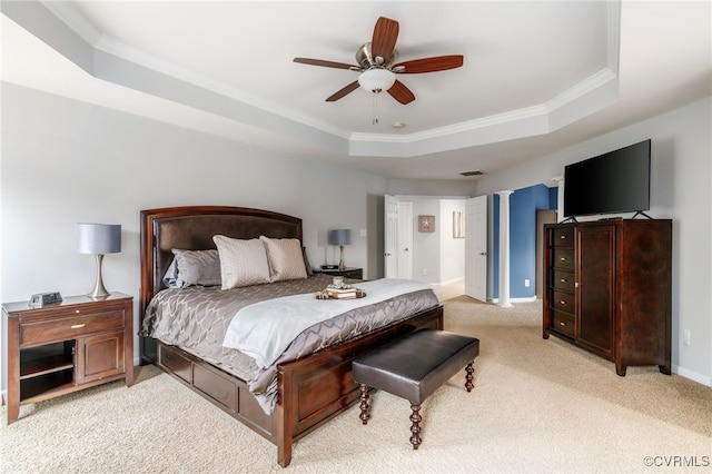 bedroom featuring baseboards, ornamental molding, a raised ceiling, and light colored carpet