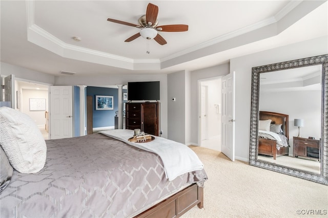 bedroom with light carpet, a tray ceiling, and ornamental molding