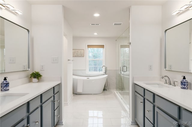 full bathroom with a stall shower, visible vents, a sink, and recessed lighting