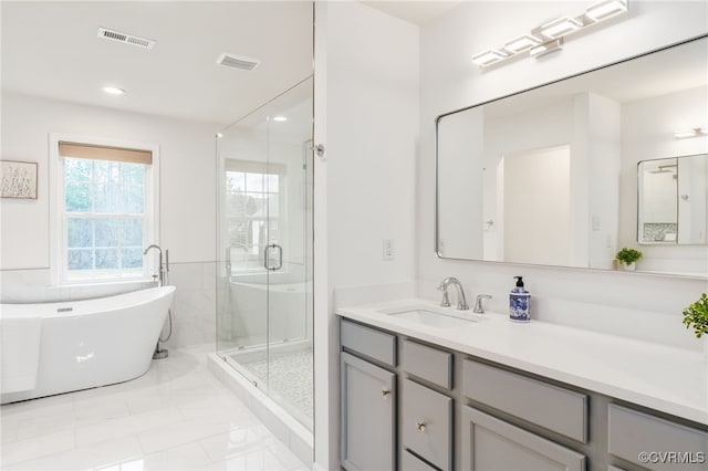 full bath featuring recessed lighting, a soaking tub, visible vents, a shower stall, and vanity