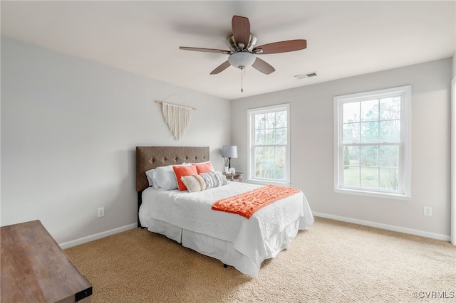 bedroom featuring carpet floors, baseboards, visible vents, and a ceiling fan