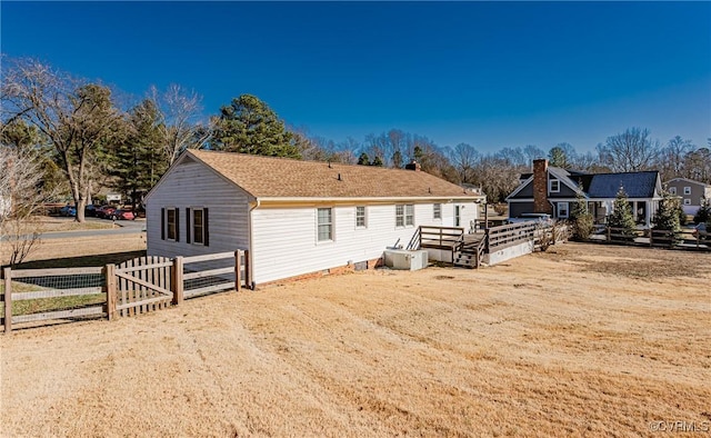 back of house with crawl space and fence