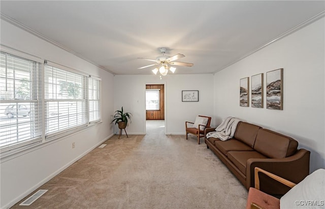 living room with baseboards, visible vents, crown molding, and light colored carpet