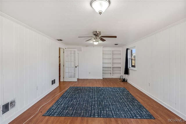 interior space with wood finished floors, visible vents, and built in features