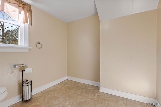 washroom with light tile patterned floors and baseboards