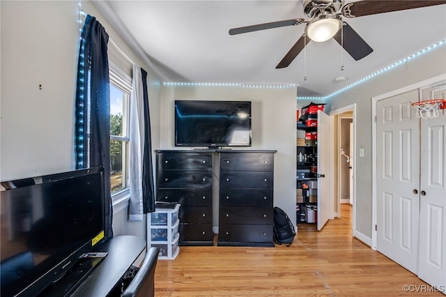 bedroom featuring a closet, a ceiling fan, and light wood-style floors