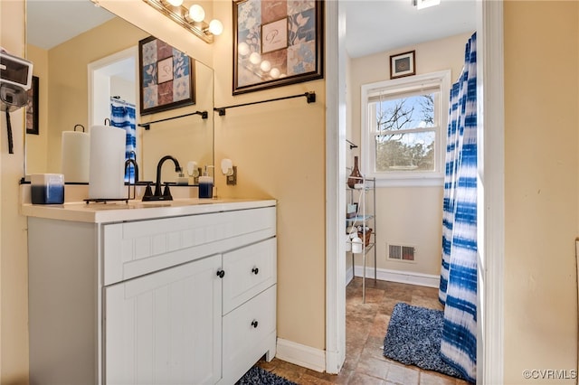 full bath featuring baseboards, visible vents, and vanity