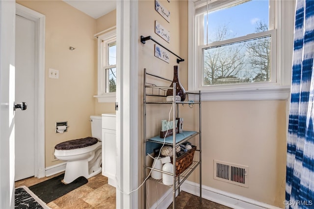 bathroom featuring toilet and visible vents