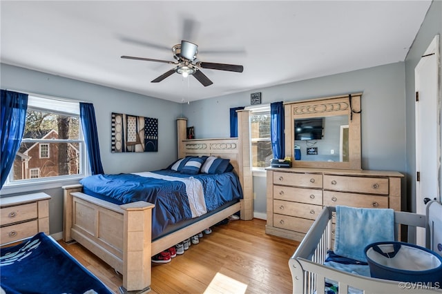 bedroom featuring light wood-type flooring and ceiling fan