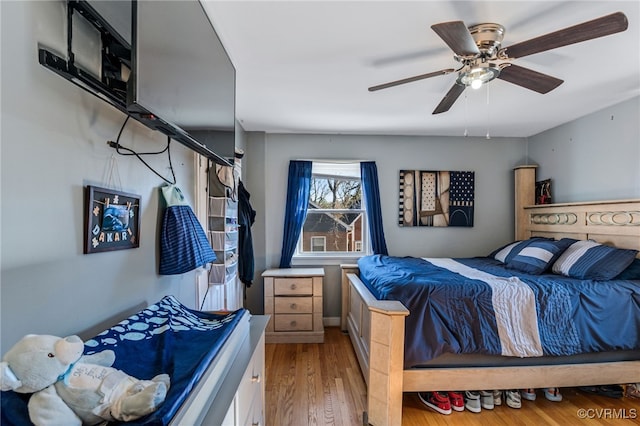 bedroom with ceiling fan and wood finished floors