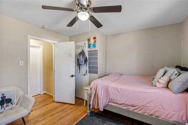 bedroom with light wood-style flooring and a ceiling fan