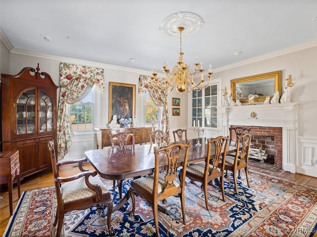 dining area with light wood finished floors, an inviting chandelier, and crown molding