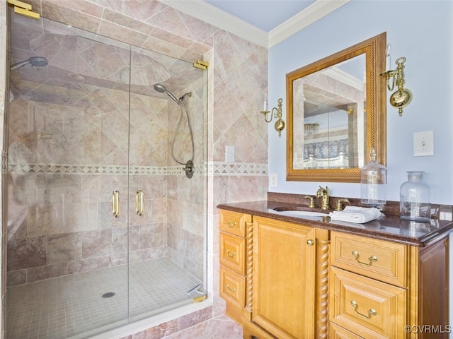 bathroom with ornamental molding, a shower stall, and vanity