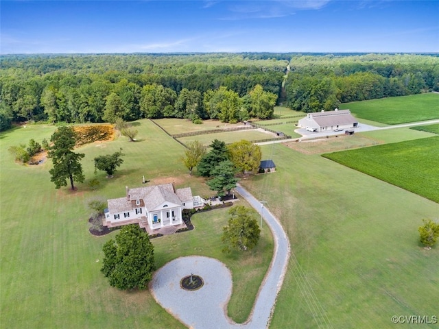 bird's eye view featuring a forest view and a rural view