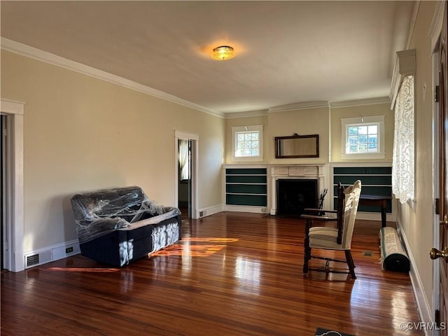 living room featuring a healthy amount of sunlight, a fireplace with flush hearth, baseboards, and wood finished floors