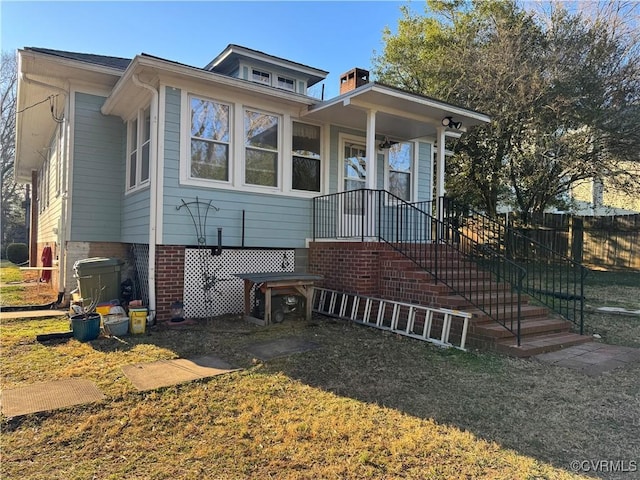 bungalow-style house featuring fence and brick siding