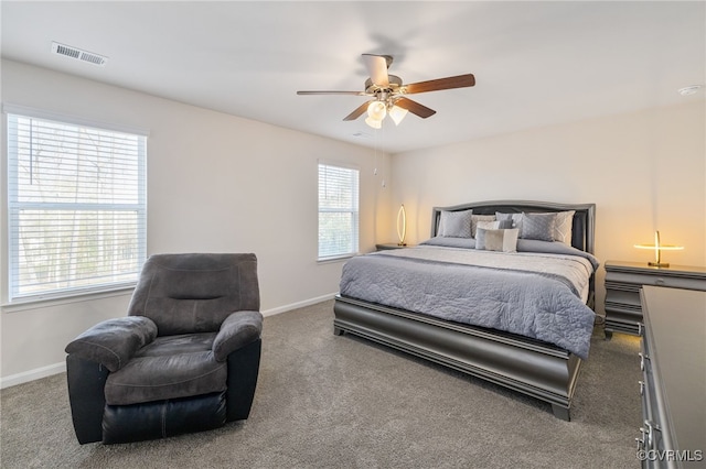 carpeted bedroom with baseboards, visible vents, and ceiling fan