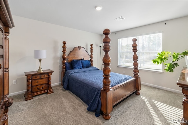 carpeted bedroom featuring visible vents and baseboards