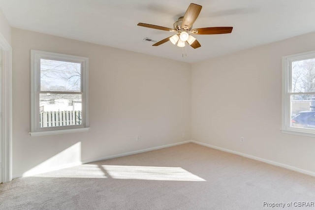 unfurnished room featuring carpet, baseboards, and ceiling fan