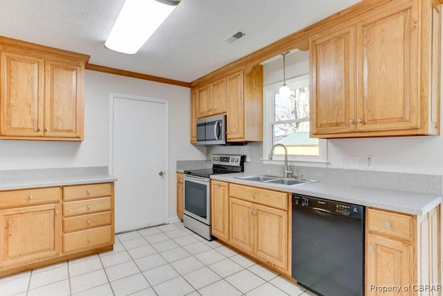 kitchen featuring stainless steel appliances, light countertops, visible vents, light brown cabinets, and a sink