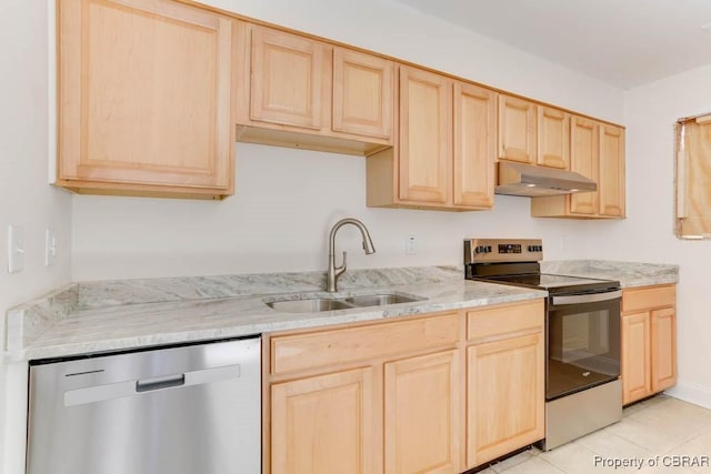 kitchen with appliances with stainless steel finishes, light stone countertops, light brown cabinetry, under cabinet range hood, and a sink