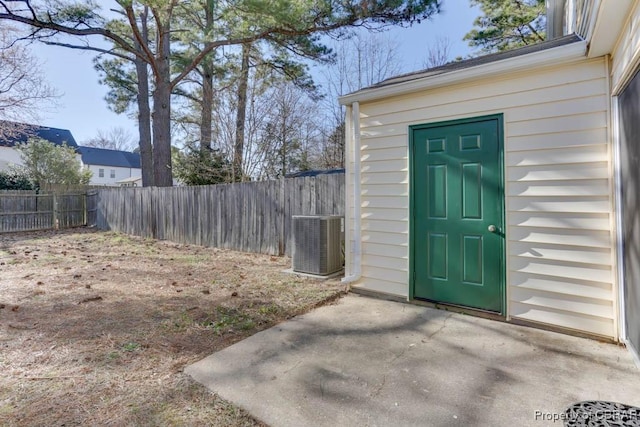 property entrance featuring fence, central AC, and a patio