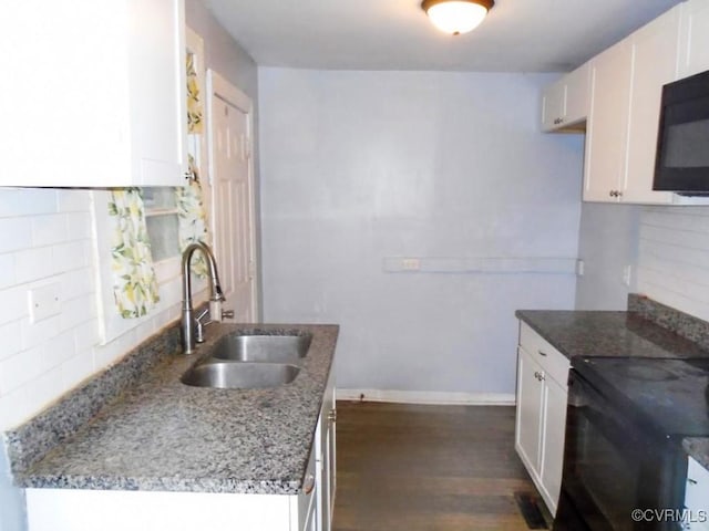 kitchen featuring tasteful backsplash, white cabinets, a sink, light stone countertops, and black appliances