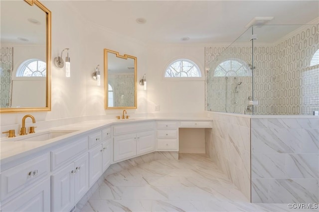 bathroom featuring a walk in shower, marble finish floor, a sink, and crown molding