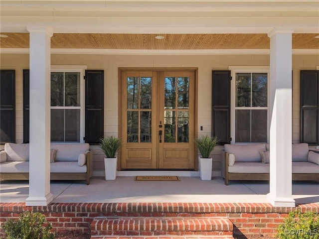 doorway to property with french doors and a porch