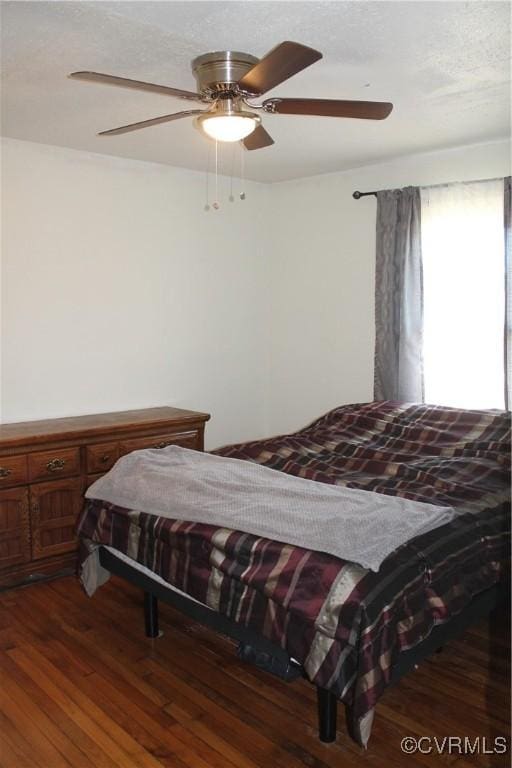 bedroom with ceiling fan and wood finished floors